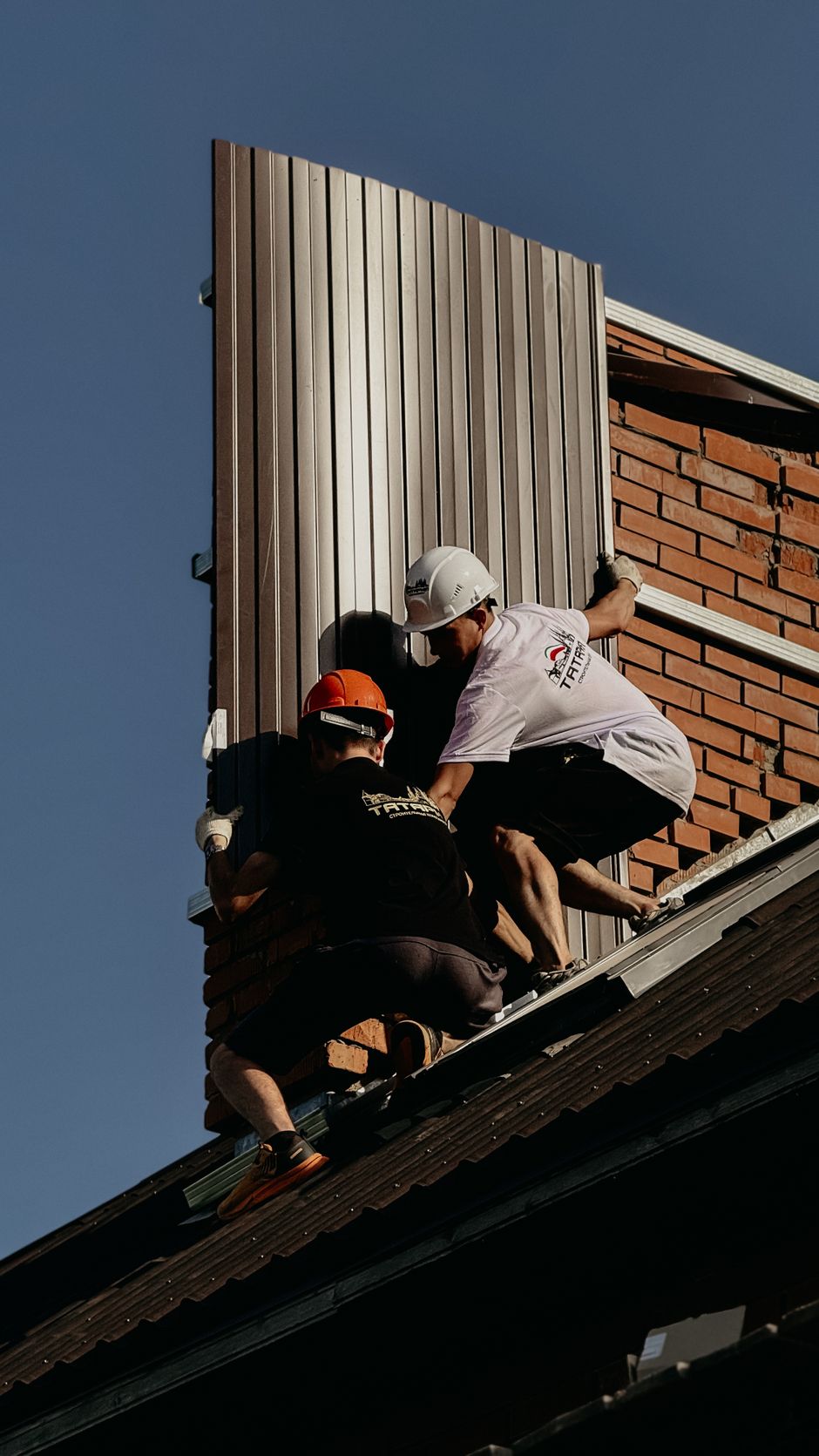 Siding repair professionals assessing damaged panels on a residential home