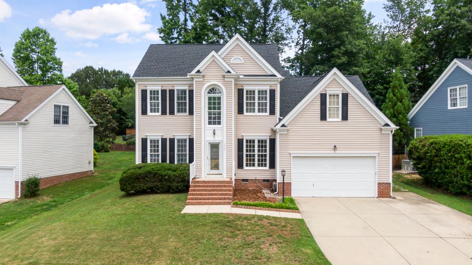 Beautiful two-story home with vinyl siding and landscaping