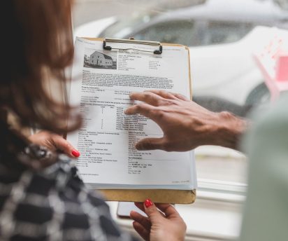 Siding contractor reviewing warranty paperwork with New Orleans homeowner