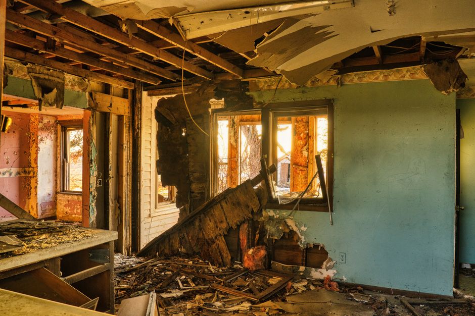 Rotted wall sheathing exposed after removing old siding in a humid climate home